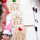 Elf on the Shelf holding message sign