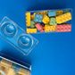 Block-themed candy favor in a brick-shaped box, perfect for birthday parties or playdates. Includes Lego-themed candies with optional cellophane wrap and thank you label. Custom candy containers available upon request.