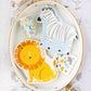 Lion-shaped paper party plates featuring a golden mane with shimmering gold foil accents, perfect for safari or jungle-themed birthday celebrations. Includes 8 plates, approximately 9" wide and 11" tall.