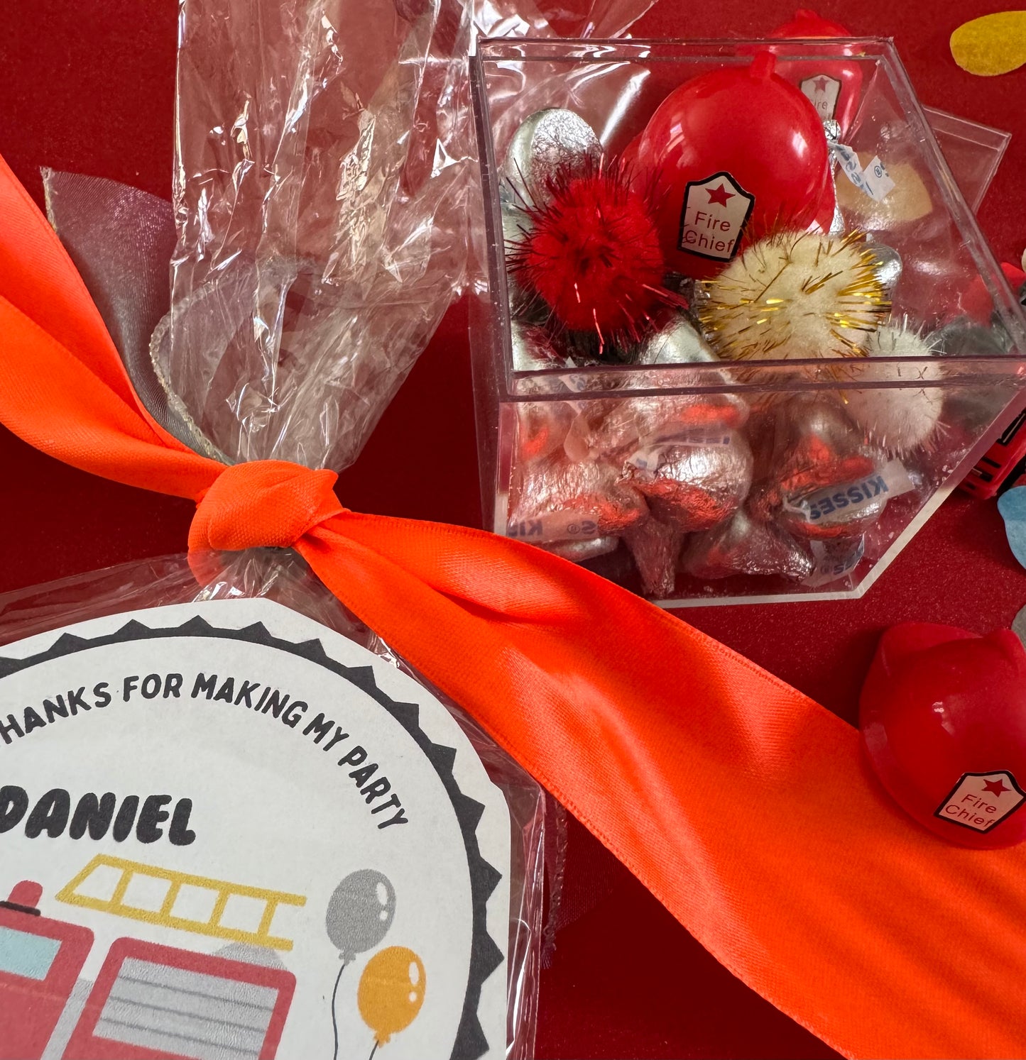 Delight in our Firetruck Themed candy favor, perfect for birthdays and firehouse play dates. This magical treat comes in a perfectly sized square plastic box filled with chocolate 'kisses' themed with firetruck labels. Each box is wrapped in cellophane and can include a thank you label. Explore more candy container options. Ideal for fire truck, firefighter, and tractor-themed parties, ensuring a delicious and fun addition to your celebration.