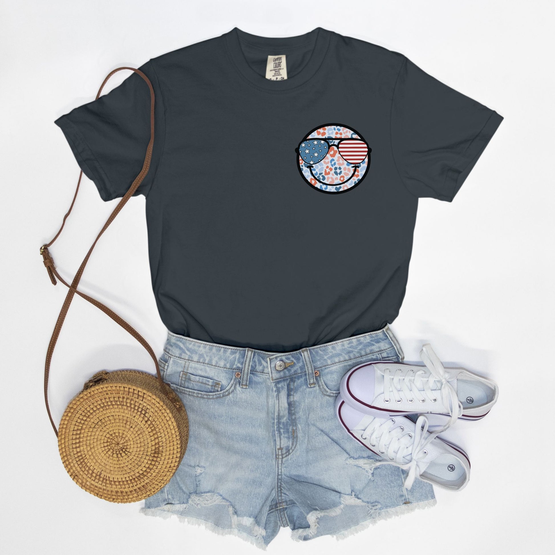 Retro smiley face sunglasses t-shirt featuring a patriotic design with American flag shades. Perfect for 4th of July celebrations, this vintage-style Comfort Colors tee is soft-washed, pre-shrunk, and available in unisex sizes. Show off 90s nostalgia with this fun and comfortable USA flag shirt, ideal for summer BBQs, fireworks, and family gatherings.