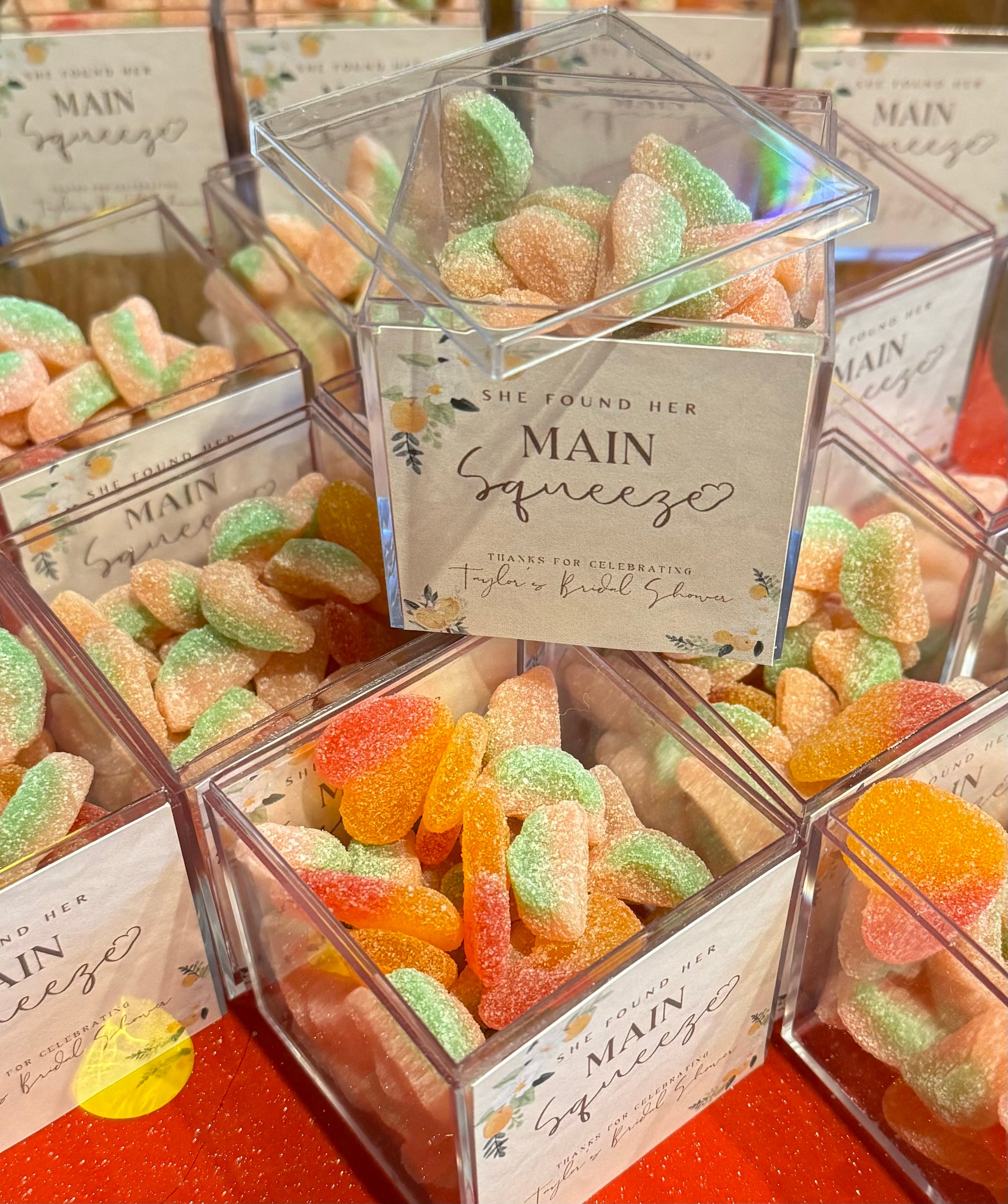 Personalized favor cubes with candy and custom labels for events or gifting.