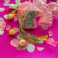 Unicorn-themed candy favor in a magical candy box featuring rainbow sour candy tails. Perfect for birthday parties and kids' celebrations. Enjoy a delightful sensory adventure with this fun and whimsical treat. Color may vary from photos.