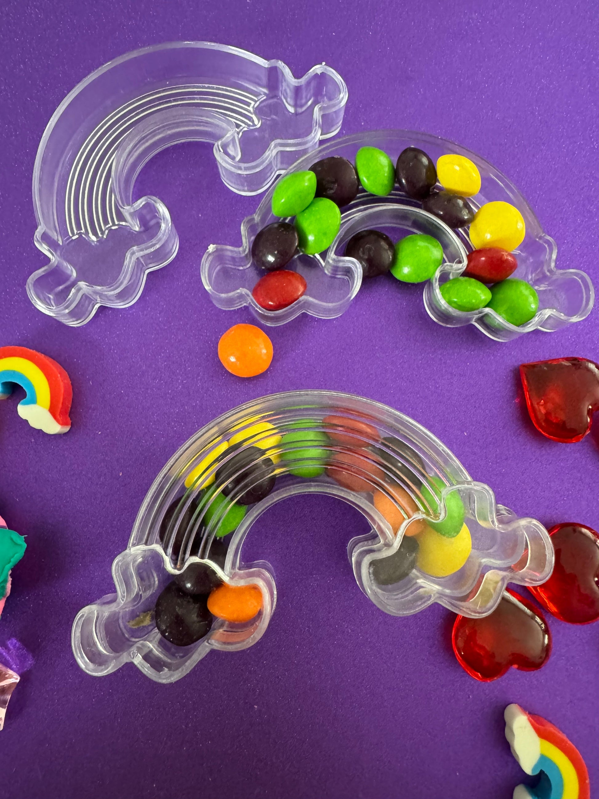 Trolls-themed birthday party favors featuring Poppy and Branch, enclosed in a rainbow-themed plastic box filled with Skittles. Perfect for celebrating and thanking guests, these candy favors are wrapped in cellophane with an optional thank you label. Great for playdates and available with other candy containers