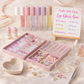 Make your own lip gloss bar kit with lip gloss containers, decorative items, and a sign on a light background.