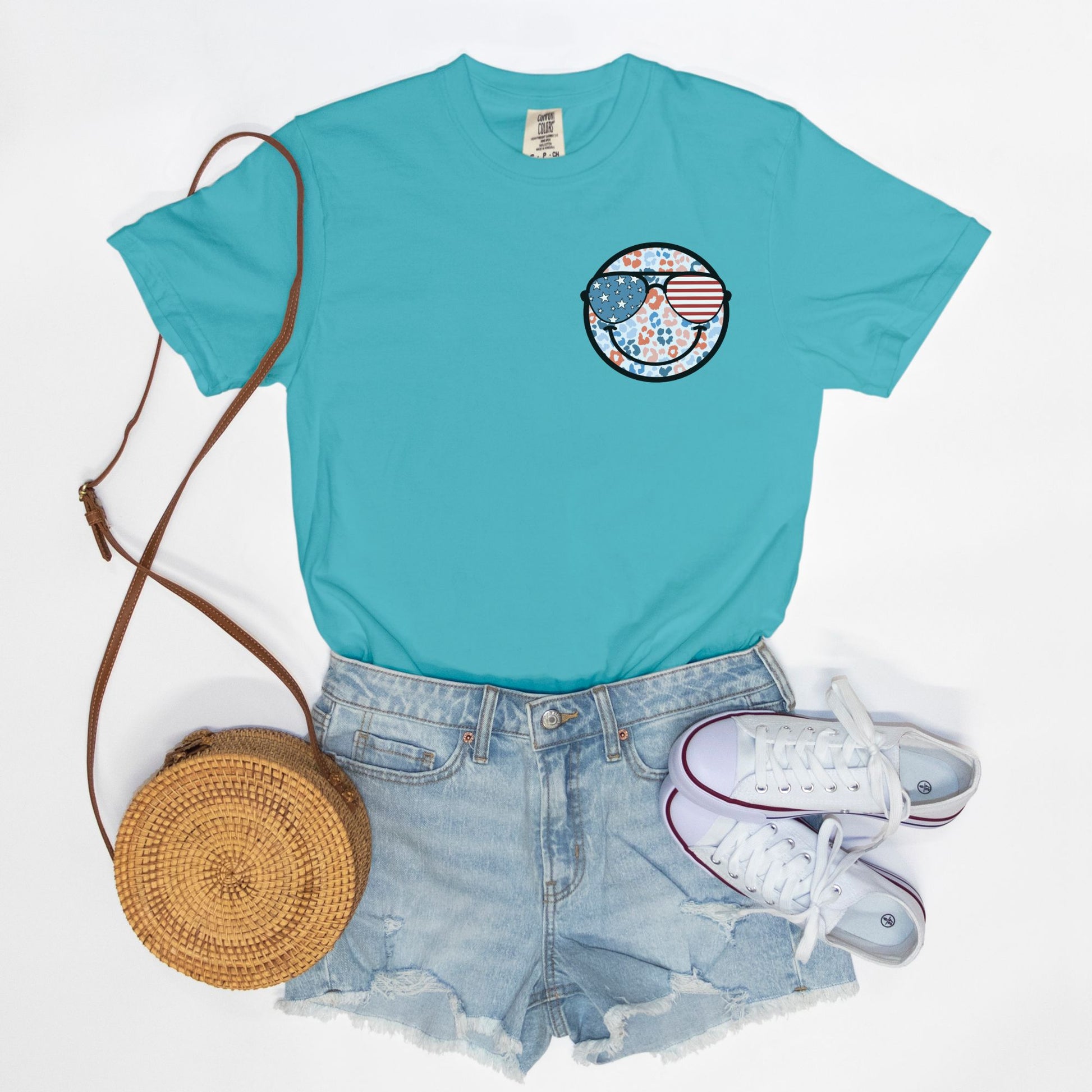 Retro smiley face sunglasses t-shirt featuring a patriotic design with American flag shades. Perfect for 4th of July celebrations, this vintage-style Comfort Colors tee is soft-washed, pre-shrunk, and available in unisex sizes. Show off 90s nostalgia with this fun and comfortable USA flag shirt, ideal for summer BBQs, fireworks, and family gatherings.