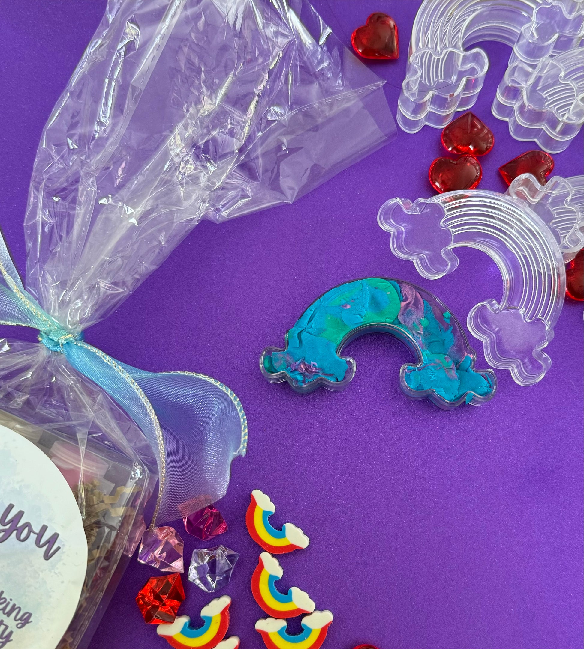 Rainbow sensory kit featuring handmade rainbow swirl glitter dough infused with confetti, miniature sensory charm mix, and soft glitter pompoms. Designed to engage senses and inspire creativity for toddlers and kids ages 3+. Promotes brain development, fine motor skills, and emotional growth. Includes small parts; parental supervision recommended.