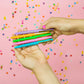 Set of 5 colorful "Best Teacher Ever" pens with matching ink colors. Medium ballpoint pens in a white gift box with gold foil dots, perfect for teacher appreciation gifts.
