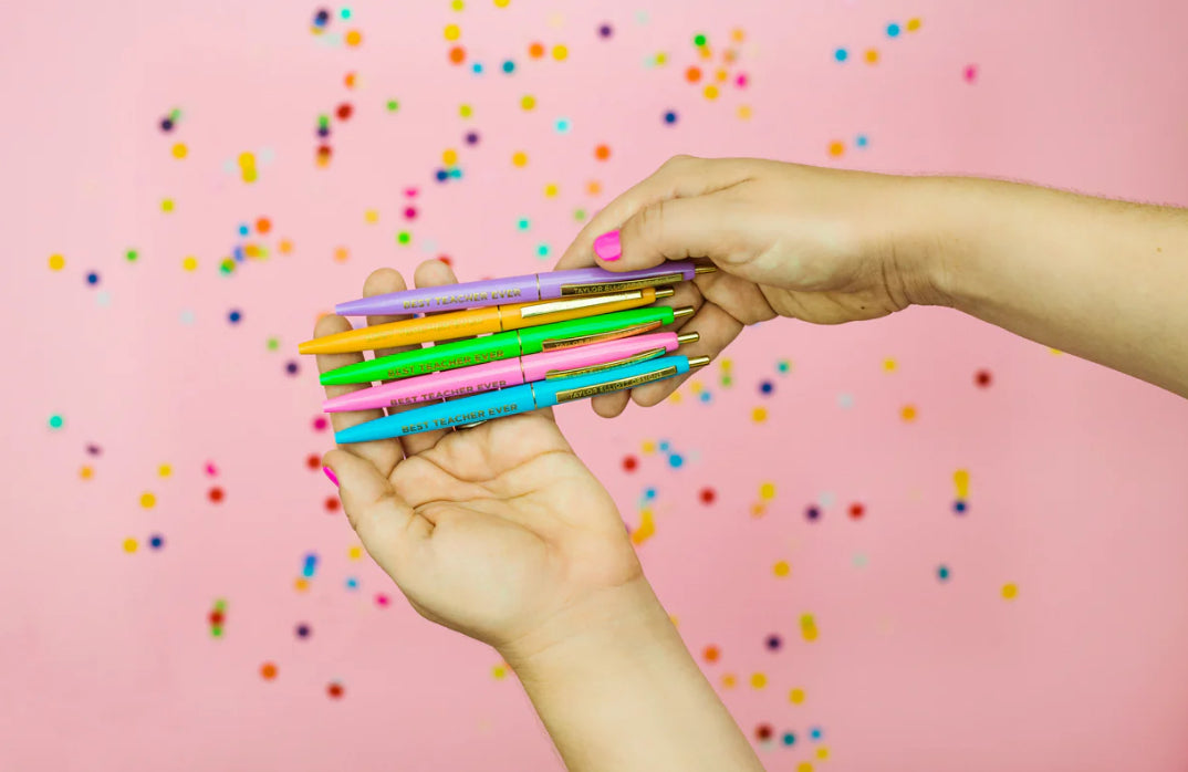 Set of 5 colorful "Best Teacher Ever" pens with matching ink colors. Medium ballpoint pens in a white gift box with gold foil dots, perfect for teacher appreciation gifts.