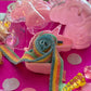 Unicorn-themed candy favor in a magical candy box featuring rainbow sour candy tails. Perfect for birthday parties and kids' celebrations. Enjoy a delightful sensory adventure with this fun and whimsical treat. Color may vary from photos.