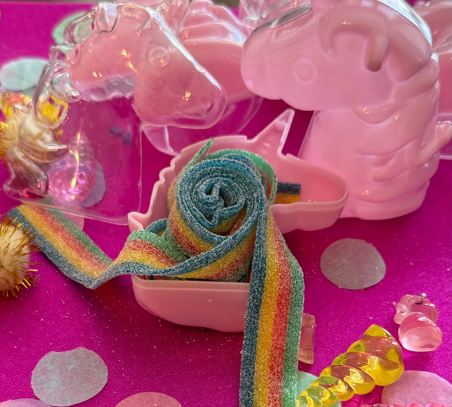Unicorn-themed candy favor in a magical candy box featuring rainbow sour candy tails. Perfect for birthday parties and kids' celebrations. Enjoy a delightful sensory adventure with this fun and whimsical treat. Color may vary from photos.