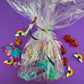 Rainbow sensory kit featuring handmade rainbow swirl glitter dough infused with confetti, miniature sensory charm mix, and soft glitter pompoms. Designed to engage senses and inspire creativity for toddlers and kids ages 3+. Promotes brain development, fine motor skills, and emotional growth. Includes small parts; parental supervision recommended.