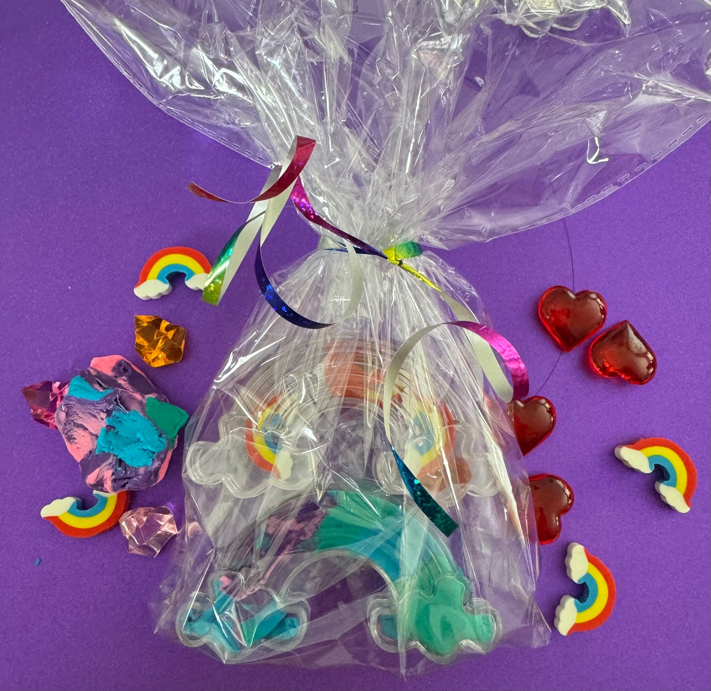 Rainbow sensory kit featuring handmade rainbow swirl glitter dough infused with confetti, miniature sensory charm mix, and soft glitter pompoms. Designed to engage senses and inspire creativity for toddlers and kids ages 3+. Promotes brain development, fine motor skills, and emotional growth. Includes small parts; parental supervision recommended.