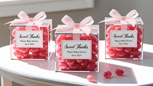 Clear acrylic candy favor cube with custom label and colorful treats inside.