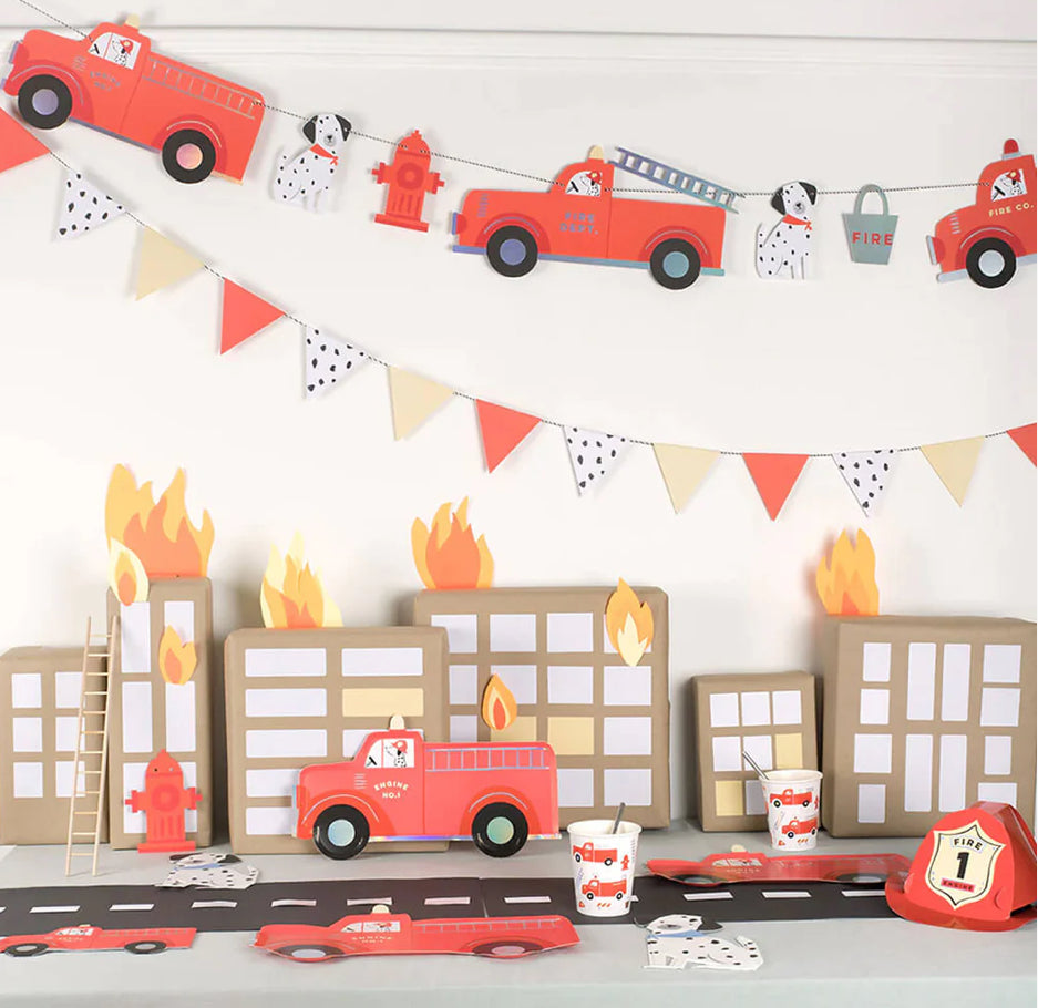 Bright red fire truck garland designed for kids' parties, featuring charming details and eco-friendly materials. Ideal for creating a fun atmosphere at fire-themed celebrations.