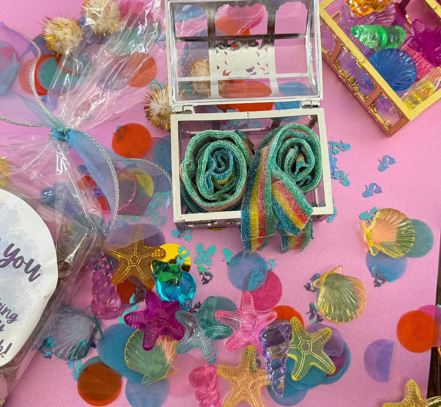 Magical Mermaid Candy favor in a gold or silver treasure chest, featuring rainbow mermaid tail candy with a sour punch. Perfect for under-the-sea or birthday party themes. Colors may vary from photos due to manufacturing differences