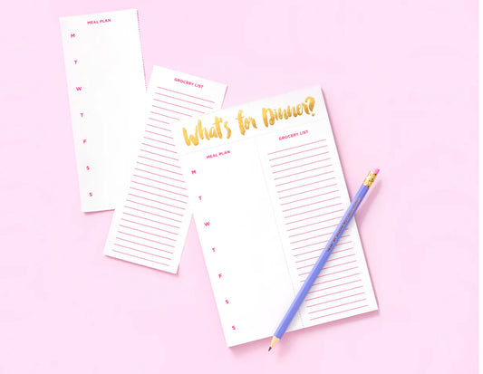 "What's For Dinner? meal planning notepad, perfect for organizing meals with ease. Size: 5.5" x 8.5", featuring 52 sheets with gold foil accents on each sheet. Includes a magnet on the back for easy display and comes in shrink-wrap packaging. 