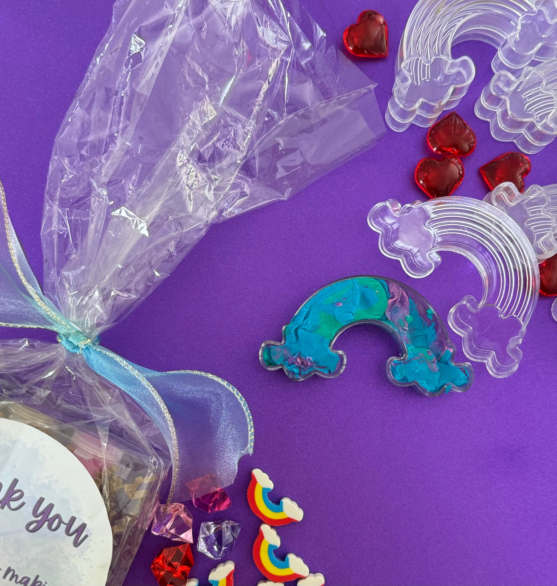 Rainbow sensory kit featuring handmade rainbow swirl glitter dough infused with confetti, miniature sensory charm mix, and soft glitter pompoms. Designed to engage senses and inspire creativity for toddlers and kids ages 3+. Promotes brain development, fine motor skills, and emotional growth. Includes small parts; parental supervision recommended.