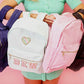 Solid backpack perfect for school, gym, or travel. Features easy clean lining and a spot clean exterior. Dimensions are 16" x 11" x 5", making it ideal for students and everyday use. Durable and versatile for multiple occasions.