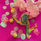 Unicorn-themed candy favor in a magical candy box featuring rainbow sour candy tails. Perfect for birthday parties and kids' celebrations. Enjoy a delightful sensory adventure with this fun and whimsical treat. Color may vary from photos.