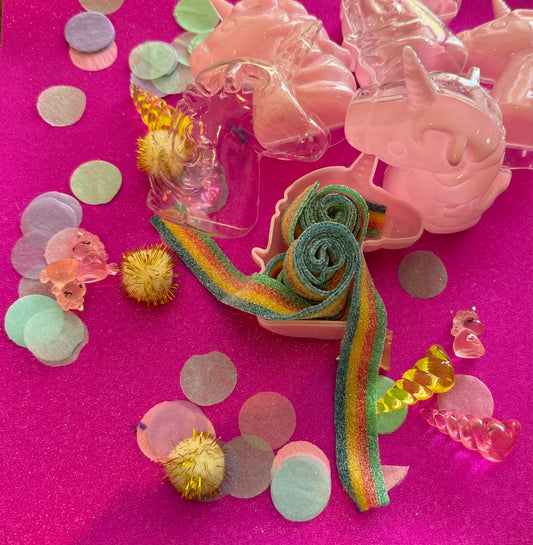 Unicorn-themed candy favor in a magical candy box featuring rainbow sour candy tails. Perfect for birthday parties and kids' celebrations. Enjoy a delightful sensory adventure with this fun and whimsical treat. Color may vary from photos.
