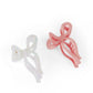 Jumbo bow claw clips in pink and white, trendy and stylish hair accessories for all hair types.