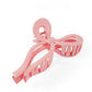 Jumbo bow claw clips in pink and white, trendy and stylish hair accessories for all hair types.