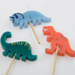 Dinosaur-Themed Party Candles Featuring Stegosaurus, Brachiosaurus, T-Rex, Diplodocus, and Triceratops on Wooden Sticks, 5 Unique Designs, 3.25 Inches Tall.