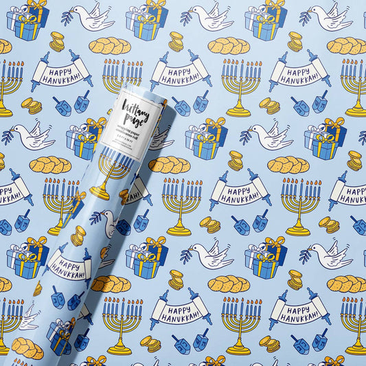 Happy Hanukkah Wrapping Paper. Festive blue, white, and gold designs featuring menorahs, dreidels, Stars of David, and 'Happy Hanukkah' messages. 2.5 x 10 ft roll of durable, premium #20 weight paper, perfect for wrapping holiday gifts. Sealed in a polly bag with a label printed on the paper.
