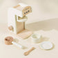 Wooden Coffee Maker Playset for kids with 4 coffee pods, cup, plate, spoon, cup holder, and 2 to-go cups. Perfect for imaginative play, allowing children to role-play as baristas, creating cappuccinos, lattes, and more. Encourages creativity and motor skills development.
