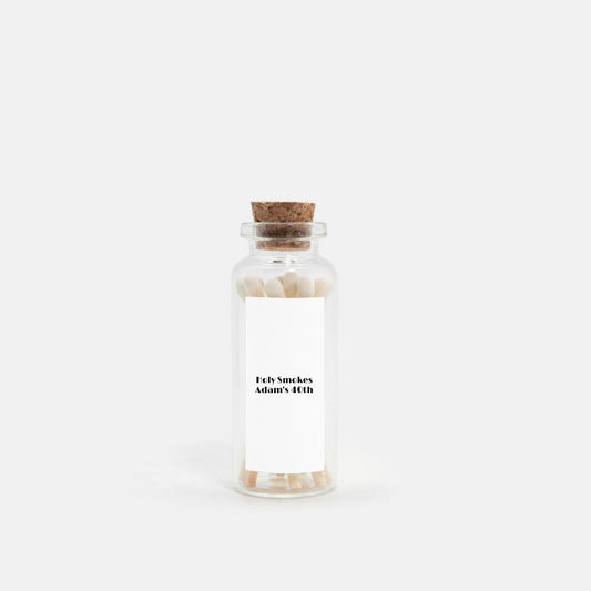 Personalized match jar party favors with 10 mini matchsticks in pink, white, or black. Glass jar with natural cork stopper and customizable label. Perfect for weddings, birthdays, bridal showers, and more. Cute, practical, and reusable gift for guests.