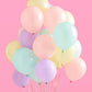 Pastel party backdrop with foil curtain and balloons