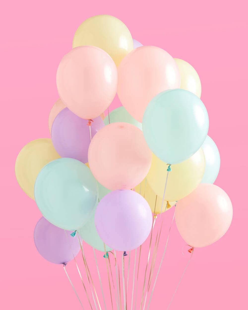 Pastel party backdrop with foil curtain and balloons