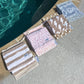 Wet bag zipped with towel inside on pool deck