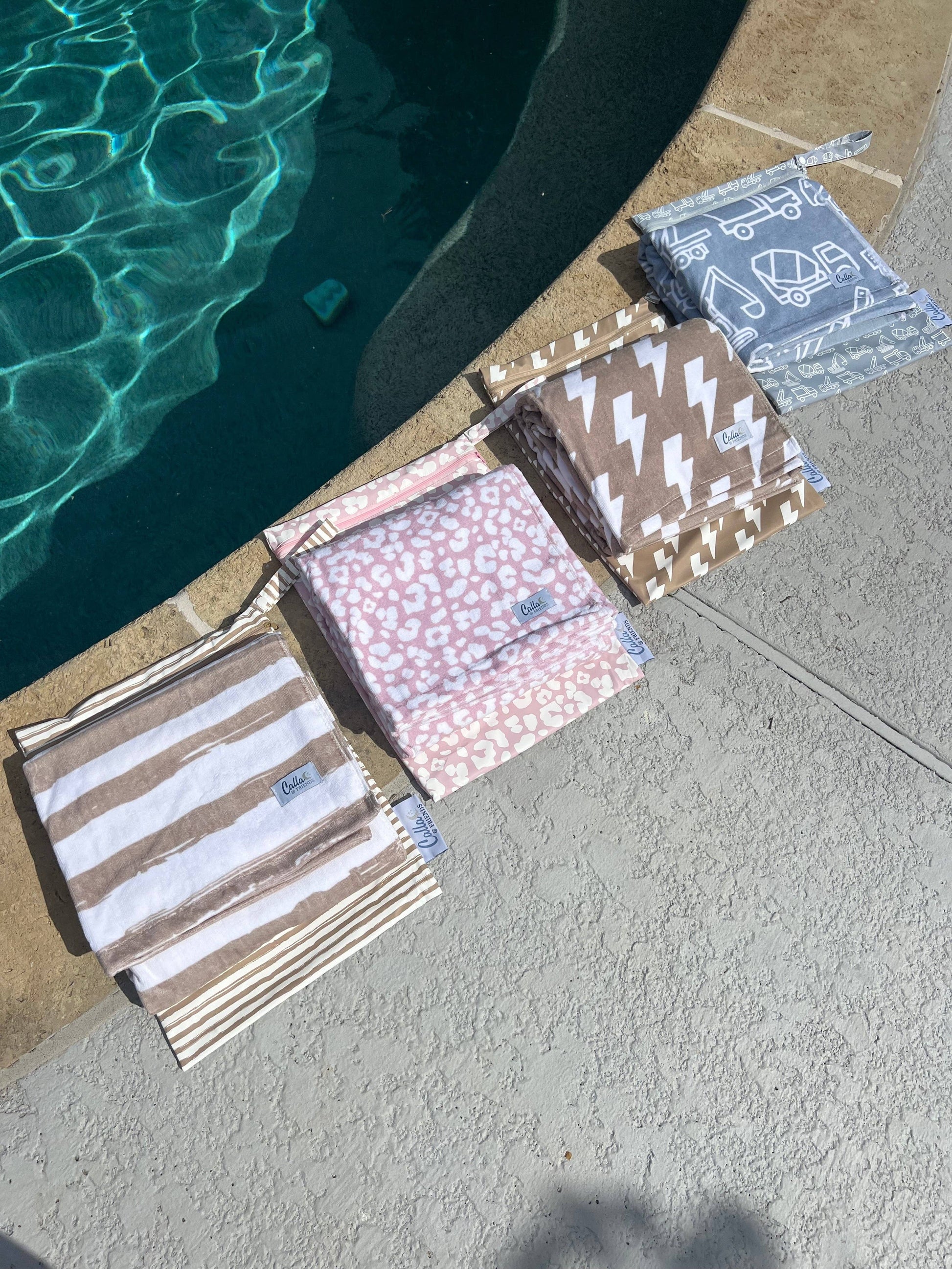 Wet bag zipped with towel inside on pool deck