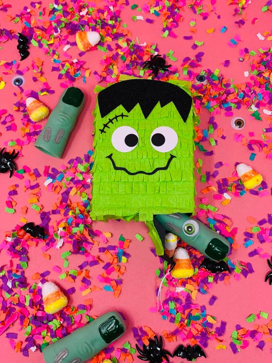 Mini Frankenstein piñata, measuring 5 inches tall, perfect for Halloween indoor decoration or party favor. Features a pull trap door for easy filling. A fun and spooky addition to Halloween events or table decor