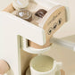 Wooden Coffee Maker Playset for kids with 4 coffee pods, cup, plate, spoon, cup holder, and 2 to-go cups. Perfect for imaginative play, allowing children to role-play as baristas, creating cappuccinos, lattes, and more. Encourages creativity and motor skills development.