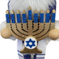 Hanukkah display nutcracker beside menorah