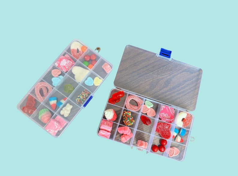 Clear box overflowing with colorful candies, offering a delightful assortment of sweets for candy lovers!