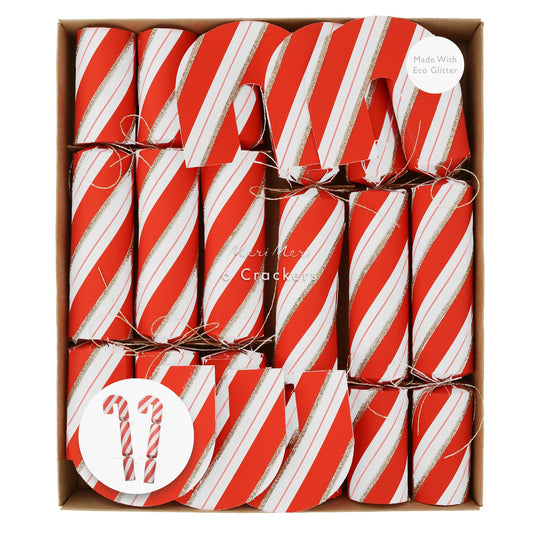 Festive candy cane crackers with gold glitter, metallic bows, party hats, jokes, and unique gifts inside.