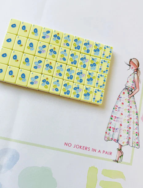 Players arranging Mahjong tiles for a game