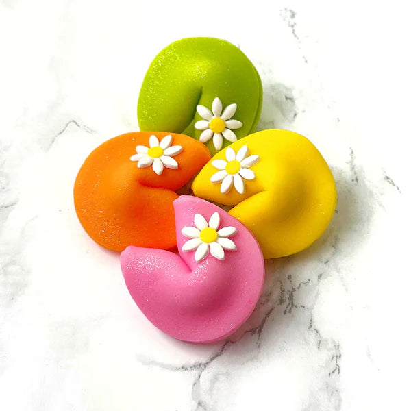 8 Easter fortune cookies made of marzipan, each with a playful Easter fortune and daisy topping.